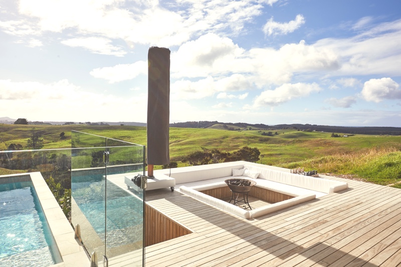 A photo of a modern deck with pool looking out over Te Arai Estate